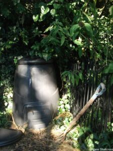 compost bin, garden fork, shadows